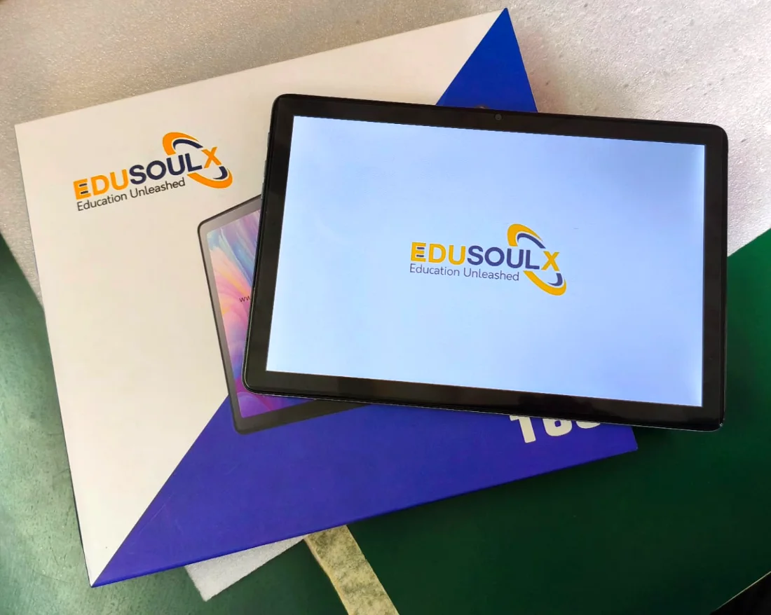 The EduSoulX T60 tablet switched on, lying on its box